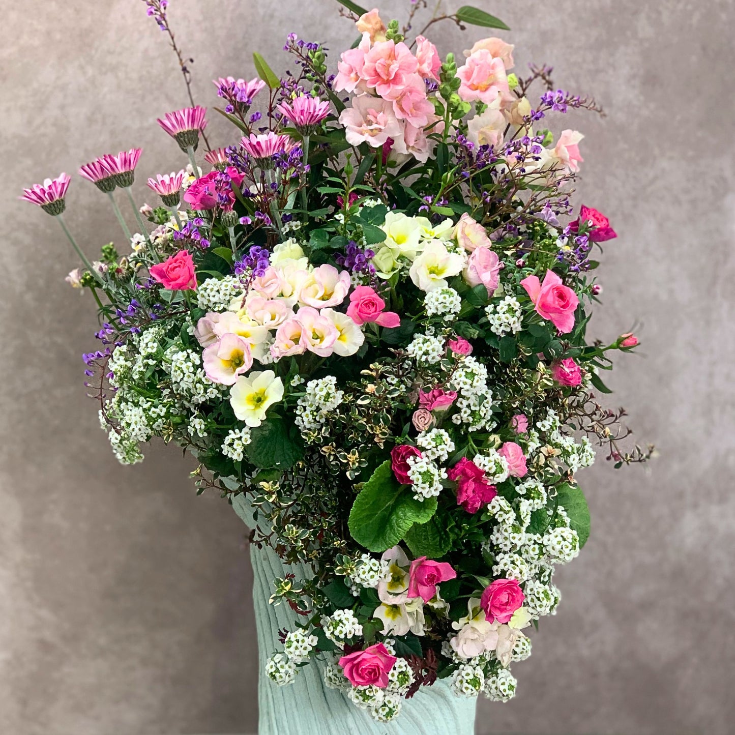 綱木紋立型ワンスリット鉢にピンク系の花苗を合わせたギャザリング寄せ植え 流れるデザインが美しく自分へのプレゼントにもおすすめ 花創人ガーデニング教室
